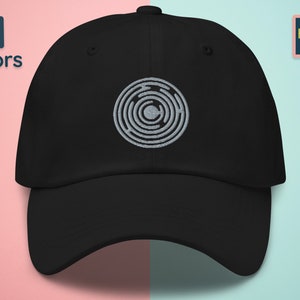 May include: A black baseball cap with a gray embroidered design of a circular maze pattern.