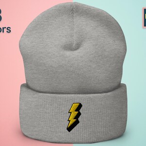 May include: Gray beanie with a yellow lightning bolt embroidered on the front. 8 colors available.