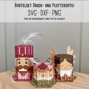 May include: Three papercraft boxes with festive designs. The boxes are in the shape of a nutcracker, a gift box with a bow, and a figure with a star on its head. The text "BASTELSET DRUCK- UND PLOTTERDATEI SVG DXF PNG" is at the top.