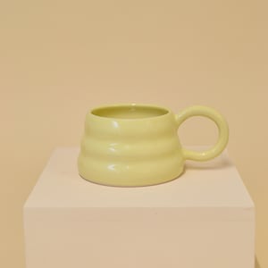 Butter yellow handmade ceramic mug with wiggly ripple shape