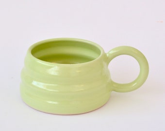 Green handmade ceramic mug with wiggly ripple shape