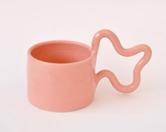 Pink handmade ceramic mug with wiggle handle