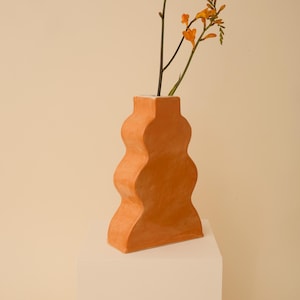 Handmade ceramic wavy vase in orange