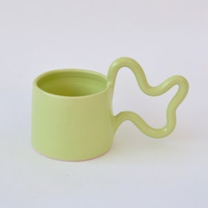 Green handmade ceramic mug with wiggle handle