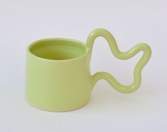 Green handmade ceramic mug with wiggle handle