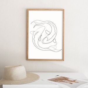 May include: A black and white line drawing of two fish swimming in a circle. The drawing is framed in a light wood frame and is hanging on a white wall.