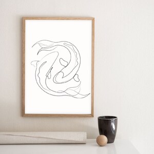 May include: A black and white line drawing of two fish swimming in a circle, framed in a light wood frame.