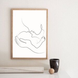 May include: A black and white line drawing of a parent holding a baby. The parent is kissing the baby on the forehead.