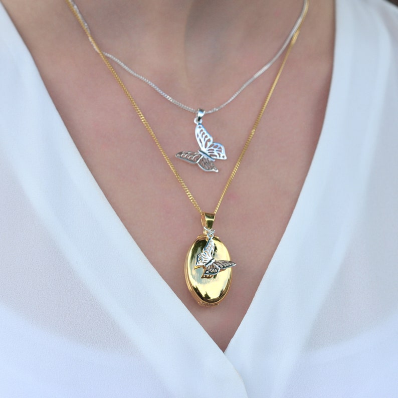 woman wearing gold oval Photo Necklace with silver butterfly charm