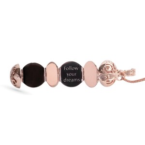 Rose Gold Locket Necklace in vintage style open on white background revealing reverse side engraved on the inner panels