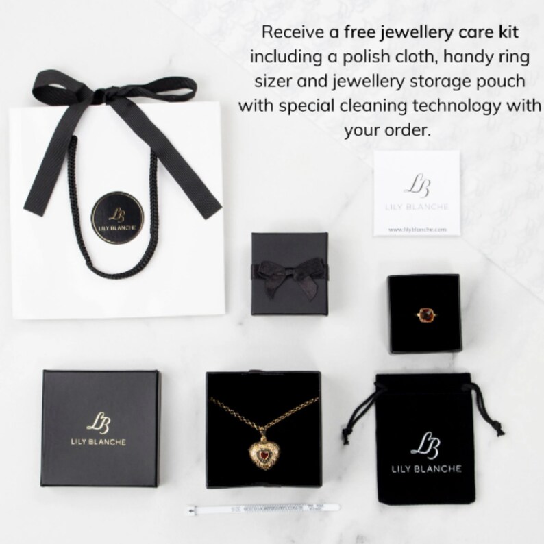 gift bag, gift box, ring box, velvet pouch, polish cloth, ring sizer, displaying gold heart locket with birthstone and birthstone ring