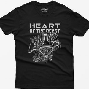 May include: Black t-shirt with a white graphic of an engine and the text "HEART OF THE BEAST". The shirt is made of cotton and has a tag that says "MADE IN USA".