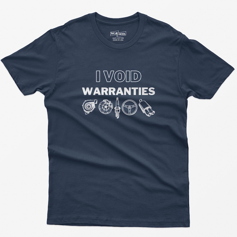 May include: A navy blue t-shirt with the text "I VOID WARRANTIES" in white. The shirt features a row of five white car part icons: a turbocharger, a spark plug, a steering wheel, and two exhaust pipes.