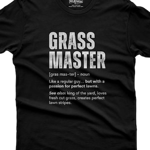 May include: A black short-sleeved t-shirt featuring white distressed text that reads GRASS MASTER, followed by the phonetic pronunciation, the definition Like a regular guy... but with a passion for perfect lawns, and See also: king of the yard.