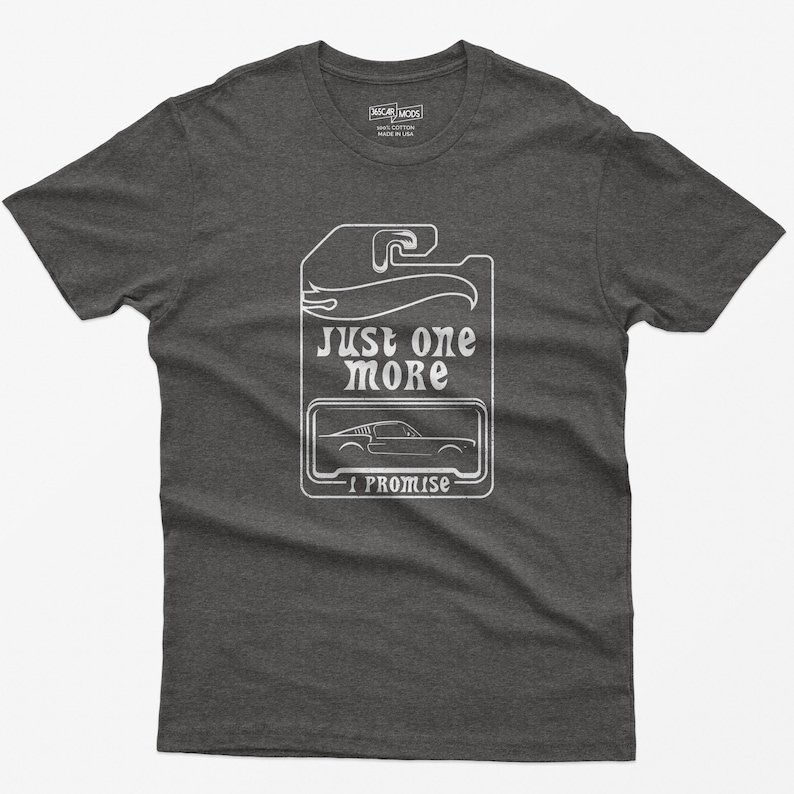 May include: A dark grey t-shirt with a white graphic of a car tag that says "Just one more I promise".
