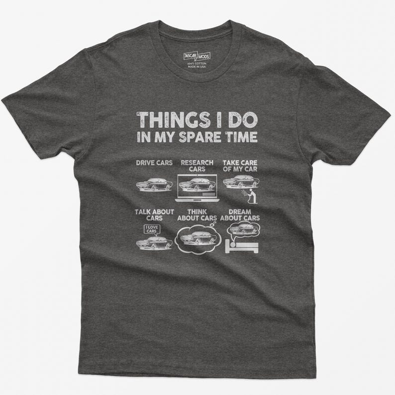 May include: A dark gray t-shirt with the text "Things I do in my spare time" and a list of car-related activities, including "Drive Cars", "Research Cars", "Take Care of My Car", "Talk About Cars", "Think About Cars", and "Dream About Cars". Each activity is illustrated with a cartoon car.