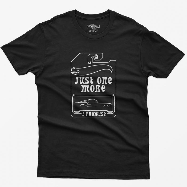 May include: Black t-shirt with a white graphic of a car and the text "Just one more I promise".