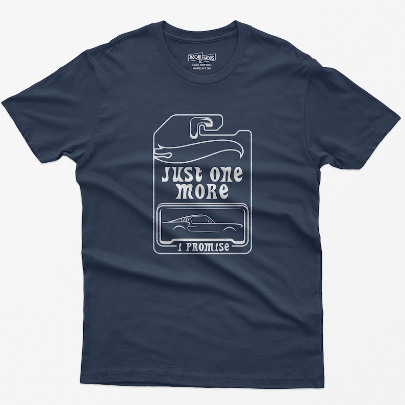 May include: Navy blue t-shirt with a white graphic of a car on a tag that says "Just one more I promise".