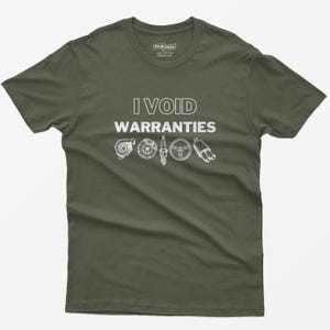 May include: A dark green t-shirt with the text "I VOID WARRANTIES" in white. The text is surrounded by small illustrations of car parts, including a turbocharger, spark plugs, a steering wheel, and an exhaust pipe.