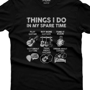 May include: A black t-shirt featuring white graphic text that reads THINGS I DO IN MY SPARE TIME, followed by six illustrations depicting guitar-related activities including playing, buying, tuning, talking, thinking, and dreaming about guitars.