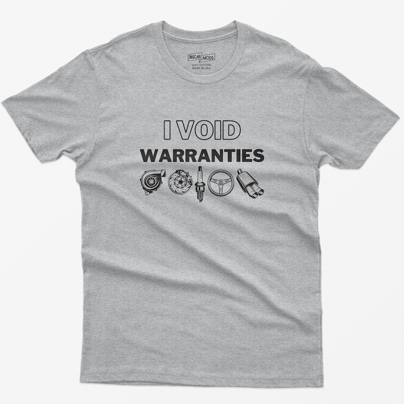 May include: A grey t-shirt with the text "I VOID WARRANTIES" in black. The text is surrounded by images of car parts, including a turbocharger, a spark plug, a steering wheel, and an exhaust pipe.