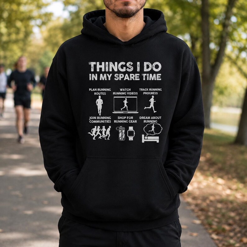 May include: A black hooded sweatshirt featuring white text that reads THINGS I DO IN MY SPARE TIME. Below the text are six icons with labels: PLAN RUNNING ROUTES, WATCH RUNNING VIDEOS, TRACK RUNNING PROGRESS, JOIN RUNNING COMMUNITIES, SHOP FOR RUNNING GEAR, and DREAM ABOUT RUNNING.