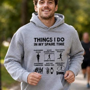 May include: A heather gray hooded sweatshirt featuring the black text "THINGS I DO IN MY SPARE TIME" above six icons and labels: "PLAN RUNNING ROUTES", "WATCH RUNNING VIDEOS", "TRACK RUNNING PROGRESS", "JOIN RUNNING COMMUNITIES", "SHOP FOR RUNNING GEAR", and "DREAM ABOUT RUNNING".
