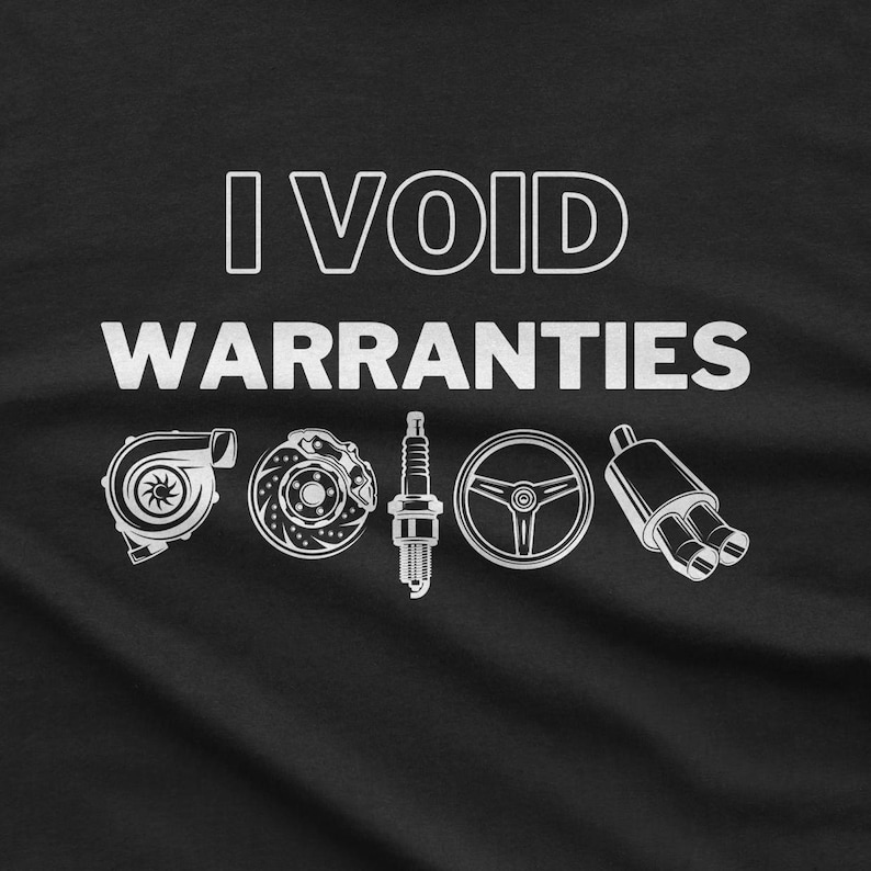 May include: Black t-shirt with white text that reads "I VOID WARRANTIES".  The text is surrounded by five white illustrations of car parts: a turbocharger, a brake rotor, a spark plug, a steering wheel, and a muffler.