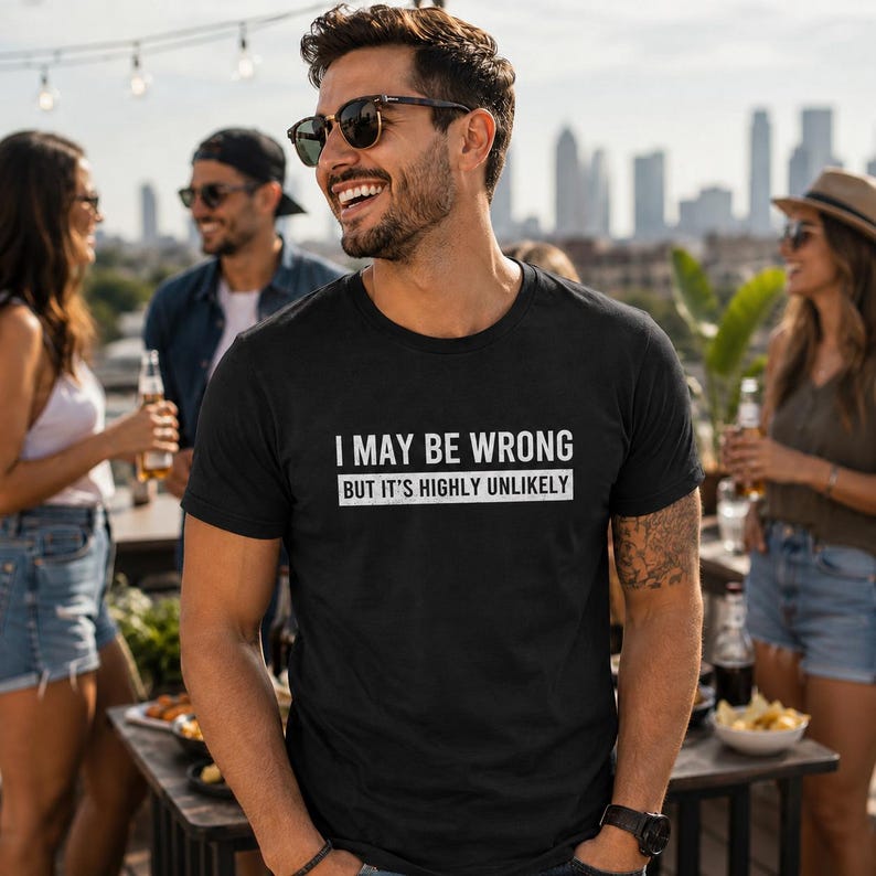 May include: A black short-sleeved t-shirt featuring white text that reads I MAY BE WRONG BUT IT'S HIGHLY UNLIKELY in a bold, sans-serif font. The shirt has a crew neckline and a standard fit, constructed from a solid black fabric.