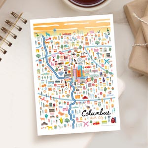 May include: A colorful illustrated map of Columbus, Ohio, featuring landmarks, buildings, and a river. The map includes the text "Columbus Arch City" in a handwritten style, with a light orange and white background.