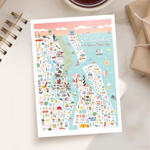 May include: A colorful map of St. Augustine, Florida, with detailed illustrations of landmarks, buildings, and vehicles. The map includes the text "St. Augustine, America's Oldest City" and is set against a light blue and pink background.