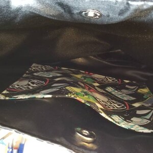 May include: Black tote bag with a black satin lining and a colorful patterned pocket inside.