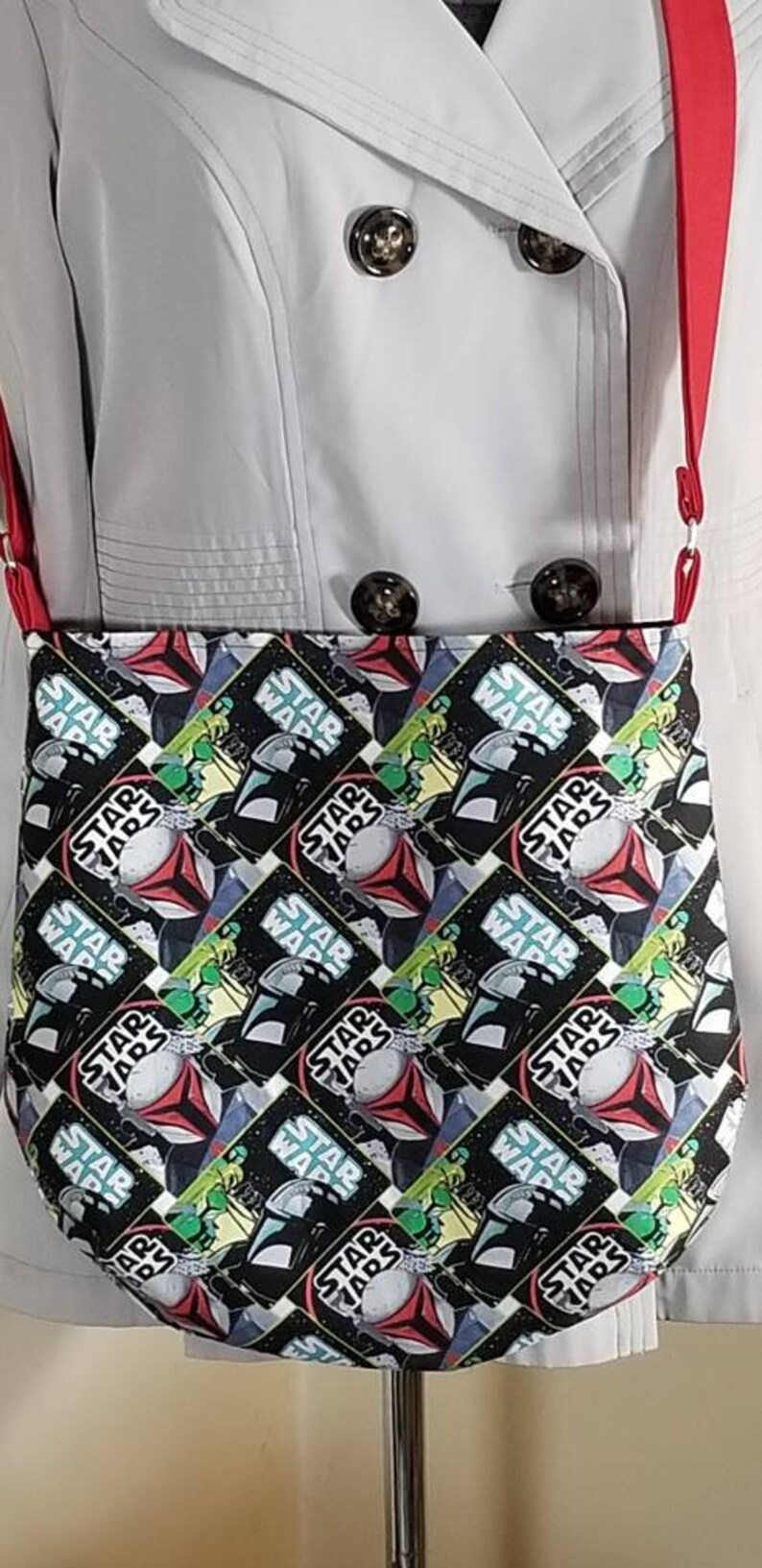 May include: A black and white Star Wars themed fabric tote bag with a red strap. The bag features a repeating pattern of Star Wars characters and the words "Star Wars".