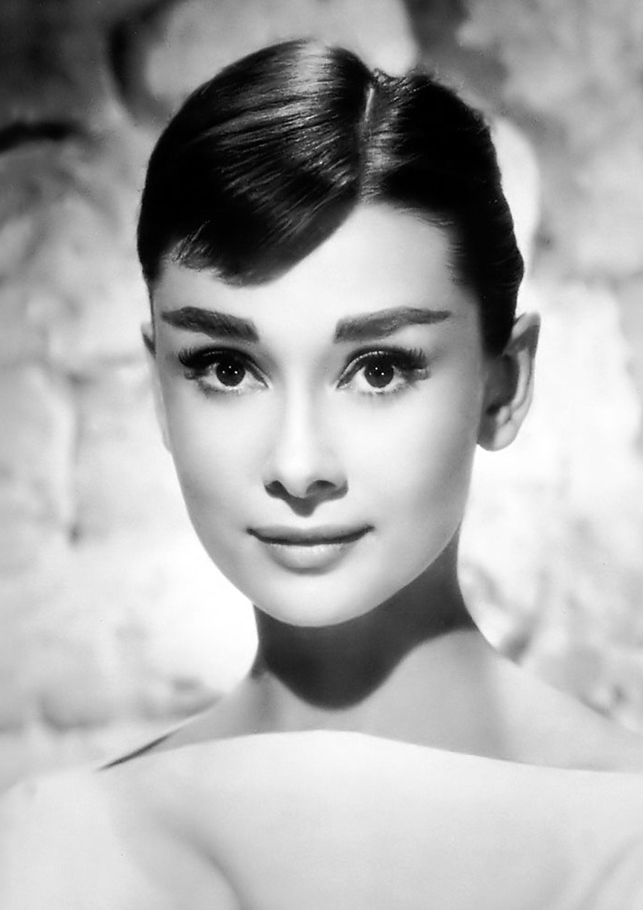 British actress Audrey Hepburn choosing a bag helped by the