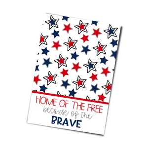 May include: A white card with a red, white, and blue star pattern. The text "HOME OF THE FREE because of the BRAVE" is printed in red on the card.