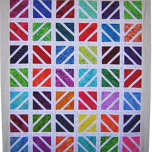 Peut inclure: Une courtepointe colorée avec un fond blanc et un motif de grille. Chaque carré de la grille est rempli d'un tissu différent avec un motif de rayures diagonales. Les tissus sont de différentes couleurs, notamment le rouge, l'orange, le jaune, le vert, le bleu, le violet et le rose.