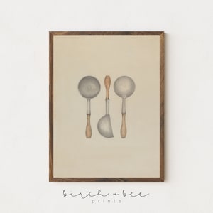 May include: A vintage-style print of three silver ladles with wooden handles on a beige background. The ladles are arranged in a vertical line with the handles pointing upwards. The print is framed in a dark wood frame.