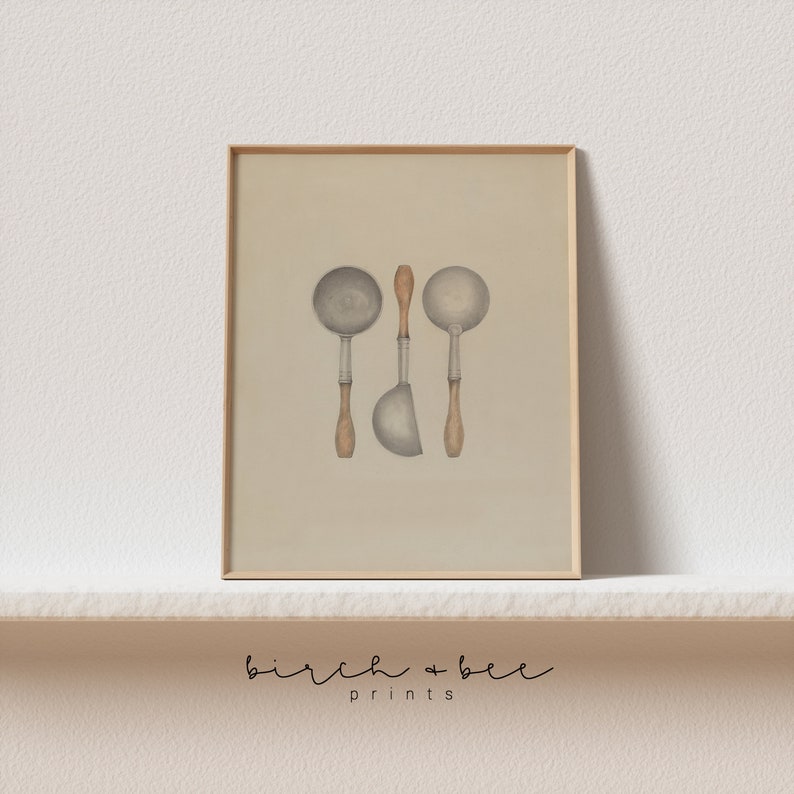 May include: A framed print of a vintage illustration of three silver ladles with wooden handles on a beige background. The print is framed in a light wood frame.