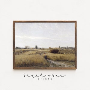 May include: A vintage painting depicting a rural landscape with a field of wheat, a dirt road, and a lone figure walking in the distance. The sky is overcast with a light blue hue. The painting is framed in a brown wooden frame.