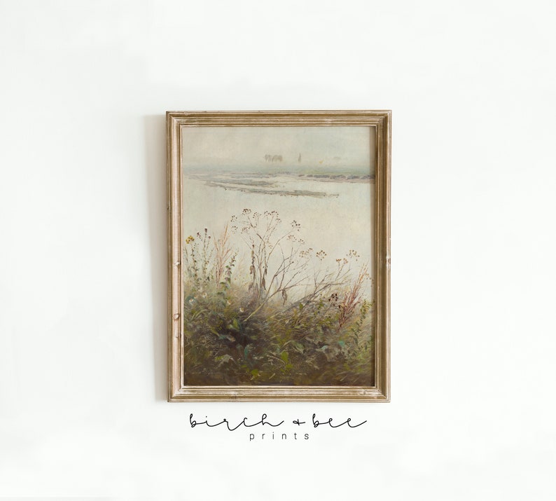 May include: A framed painting of a foggy landscape with a river and tall grasses in the foreground. The painting is in a light brown frame with a white mat.