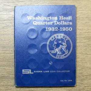 May include: A blue coin collector's album for Washington Head Quarter Dollars from 1932-1950. The cover features the text "Washington Head Quarter Dollars 1932-1950" and a silver coin illustration. The album is from Shore Line Coin Collector.
