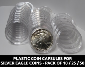 May include: Clear plastic coin capsules for Silver Eagle coins. The image shows several stacks of clear, cylindrical capsules, with one coin visible inside a capsule. Text at the bottom reads: "PLASTIC COIN CAPSULES FOR SILVER EAGLE COINS - PACK OF 10 / 25 / 50."