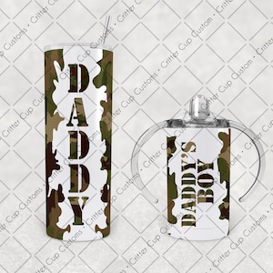 May include: A set of two tumblers with a camouflage pattern and white text. The larger tumbler says "DADDY" and the smaller tumbler says "DADDY'S BOY".
