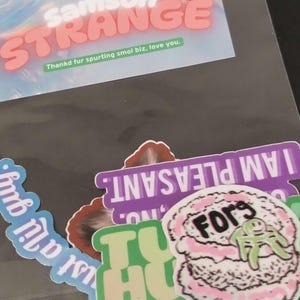 May include: A set of three ceramic mugs with a speckled, matte finish. The mugs are in shades of cream, light gray, and dark gray. Each mug has a simple, minimalist design, perfect for coffee or tea.