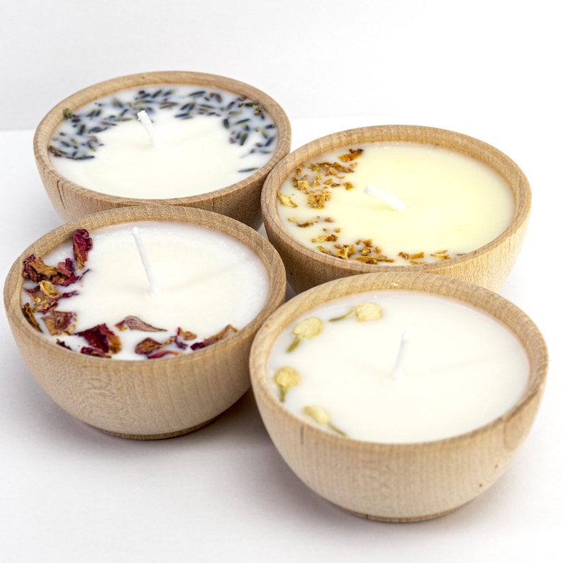 Set of four one ounce aromatherapy candles in a wooden cup reusable eco friendly sustainable pure soy and essential oil candle lavender eucalyptus orange grapefruit rosemary palmarosa essential oils and custom oil blends for calm gift relax spa gift Set of four essential oil soy tealight candles from Megan’s Pantry in reusable wooden bowls, adorned with botanicals—natural, eco-friendly aromatherapy gift set.