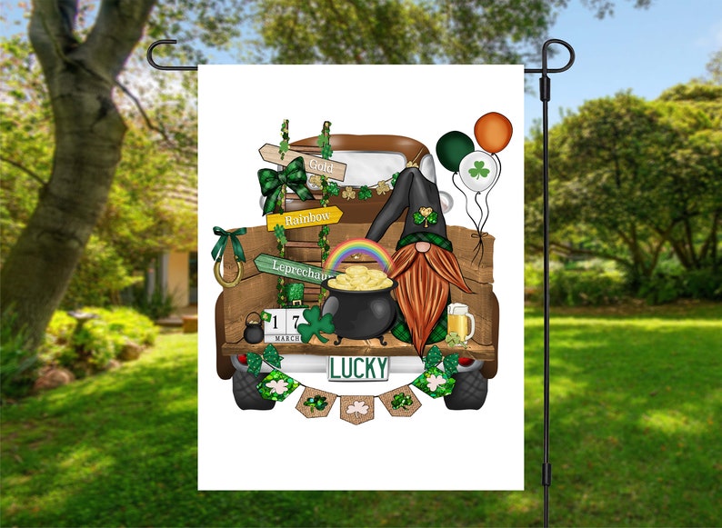 May include: A green, white, and brown gnome with a red beard is sitting in the back of a brown pickup truck. The truck is decorated with shamrocks, a rainbow, and a pot of gold. The truck has a license plate that says "LUCKY".