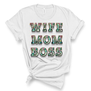 May include: White t-shirt with the text "Wife Mom Boss" in black letters with a floral pattern inside each letter.