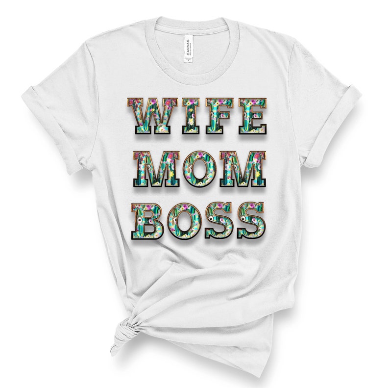 May include: White t-shirt with the text "Wife Mom Boss" in black letters with a floral pattern inside each letter.