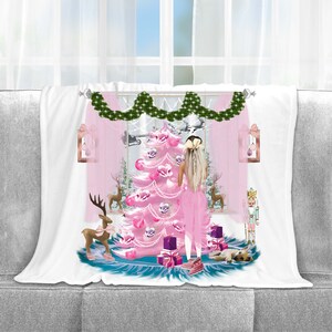 May include: A white throw blanket with a pink Christmas tree, a girl in a pink dress, and a nutcracker. The tree is decorated with pink ornaments and white lights. There are also pink and white presents under the tree.