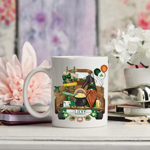 May include: White ceramic mug with a colorful illustration of a gnome driving a truck decorated with shamrocks, rainbows, and a pot of gold. The truck has a license plate that says "LUCKY".